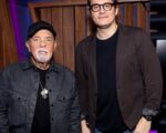 How’s Life With John Mayer? Listeners Will Learn More John Mayer poses with Billy Joel (l)