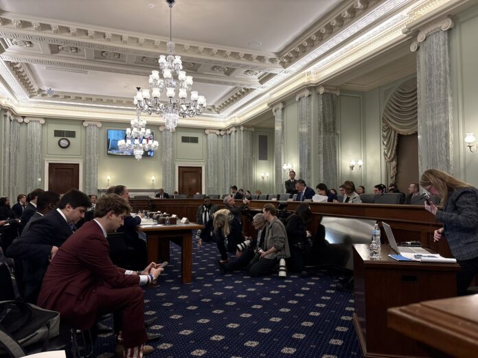 Senate Commerce Committee Chairman Ted Cruz (R-Tex.) is seated next to Minority Leader Maria Cantwell (D-Wash.) and Sen. Amy Klobuchar (D-Minn.)