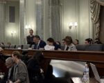 Will A Congressional Boar’s Head Thwart Thumann Nomination? Senate Commerce Committee Chairman Ted Cruz (R-Tex.) is seated next to Minority Leader Maria Cantwell (D-Wash.) and Sen. Amy Klobuchar (D-Minn.)