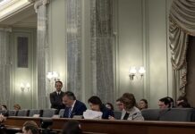 Will A Congressional Boar’s Head Thwart Thumann Nomination? Senate Commerce Committee Chairman Ted Cruz (R-Tex.) is seated next to Minority Leader Maria Cantwell (D-Wash.) and Sen. Amy Klobuchar (D-Minn.)