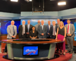 FCC Commissioner Olivia Trusty is seated at the anchor desk of Gray Media-owned WIBW-TV in Topeka, Ks.