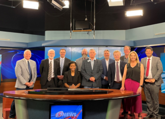 A Trusty Trip Yields Gray Media Station, Bonneville HQ Visits FCC Commissioner Olivia Trusty is seated at the anchor desk of Gray Media-owned WIBW-TV in Topeka, Ks.