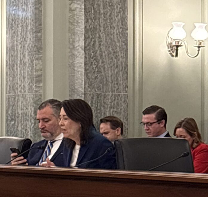 Sen. Ted Cruz (R-Tex.) checks his smartphone as Ranking Member Maria Cantwell (R-Wash.) delivered her opening statement in a February 10, 2026 hearing on the national TV ownership reach limits.