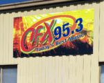 A Black Diamond Key Swipe To a Mitten State FM WCFX building signage